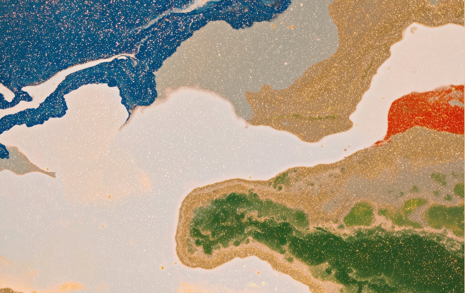 Abstract marbled ink in blue, gold, green and red with fine speckling